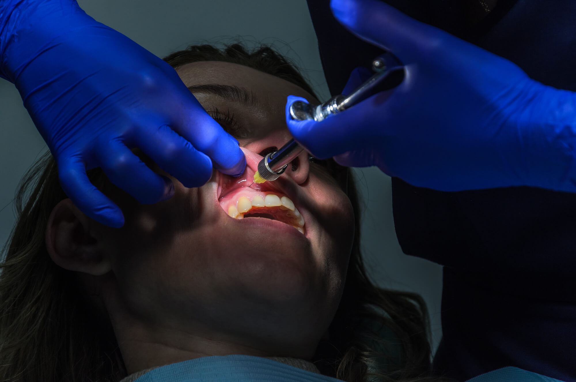 dentist giving anesthesia to patient before periodontal therapy in Senca